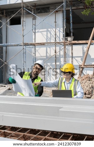 Caucasian engineer man and woman working with paper work at construction site	