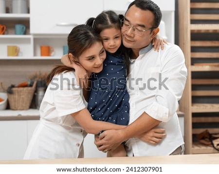 Asia father And mother hug daughter at home