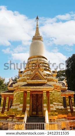 Golden Pagoda in Thakhanun temple of  Kanchanaburi Province,Thailand.Thailand travel concept.Vertical.