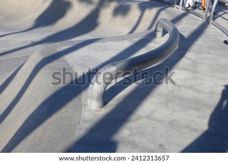 A view of a rail at a skate park.
