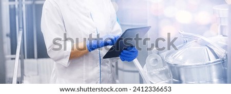 Concept food quality industrial banner. Factory worker with computer tablet inspecting production line tanker of dairy factori. Royalty-Free Stock Photo #2412336653
