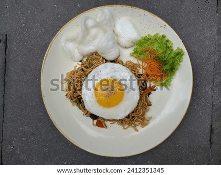 Fried noodles, an Indonesian breakfast menu served on a plate