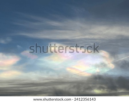 Rainbow coloured Nacreous Clouds in a winter sky. Royalty-Free Stock Photo #2412356143
