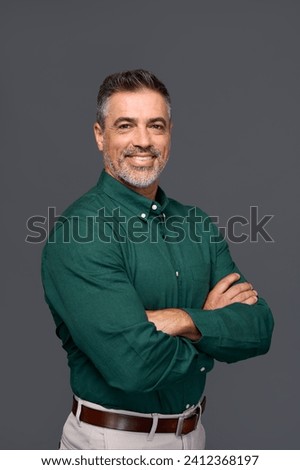 Happy middle aged business man entrepreneur, smiling mature professional confident businessman leader investor wearing green shirt standing arms crossed isolated on gray. Vertical portrait. Royalty-Free Stock Photo #2412368197