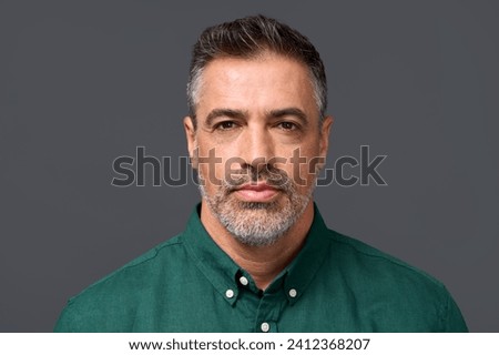 Confident middle aged business man entrepreneur, unsmiling mature professional executive manager, businessman leader investor wearing green shirt isolated on gray, headshot close up portrait. Royalty-Free Stock Photo #2412368207