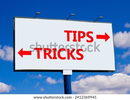 Tips and tricks symbol. Concept word Tips and tricks on beautiful billboard with two arrows. Beautiful blue sky with clouds background. Business and Tips and tricks concept. Copy space.