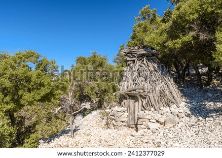 Traditional sheepfold in the mountain region of Supramonte of Baunei, in Sardinia, called Su Cuile in the local language Royalty-Free Stock Photo #2412377029