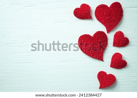 Set of hearts on a white wooden table with a lot of texture.