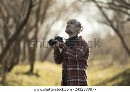 professional photographer taking nature photos in autumn