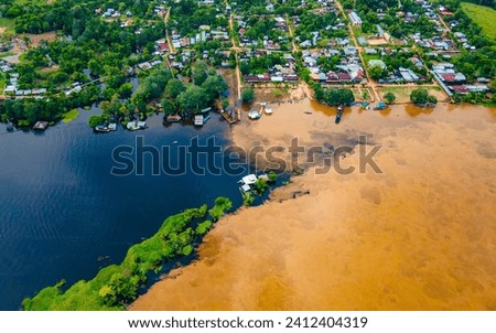 Aerial view of the stunning contrast between dark and muddy waters in Puerto Nariño, Colombia Royalty-Free Stock Photo #2412404319
