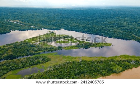 Aerial view of the lush Amazon rainforest, winding rivers, and serene lakes in Amazonas, Colombia Royalty-Free Stock Photo #2412405785