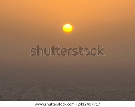 Sun with slight Cloud Formations before Sunset over the Mediterranean Sea Amazing View  Royalty-Free Stock Photo #2412407917