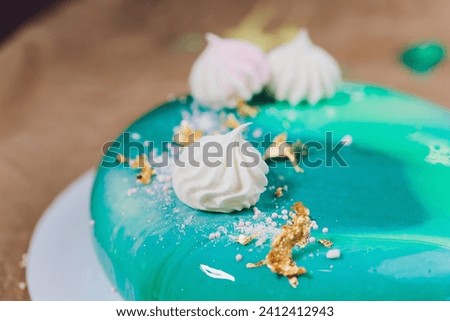 Modern French mousse cake with green mirror glaze. Picture for a menu or a confectionery catalog