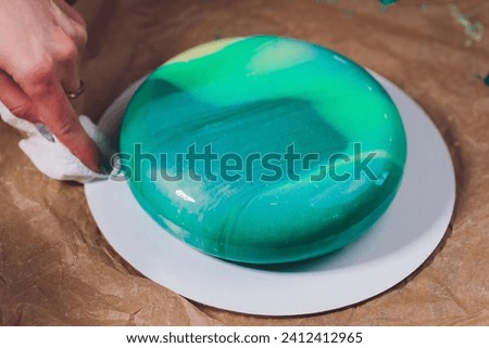 Modern French mousse cake with green mirror glaze. Picture for a menu or a confectionery catalog