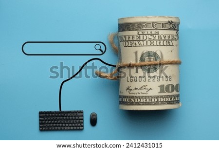 A flatlay picture of miniature keyboard, mouse, fake money and search tab on blue background