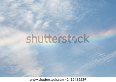 It is a picture of a rainbow in the sky.