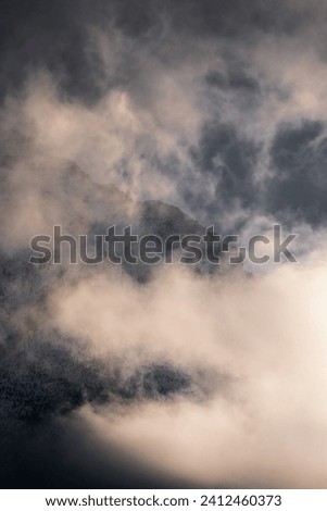 Moody morning fog and atmosphere in the Canadian Rockies reflecting on the snow covered alpine peaks
