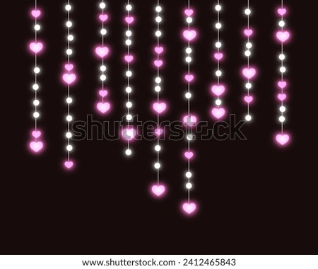Pink heart light hanging on black background 