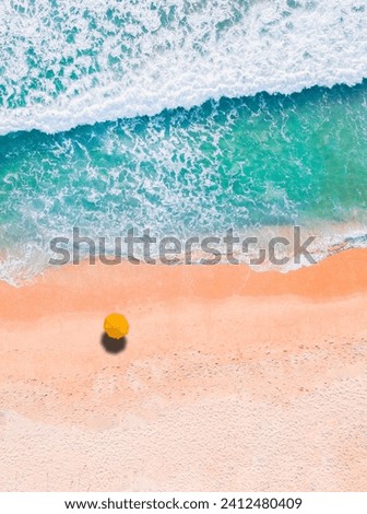 beautiful aerial shot of the sea with an umbrella