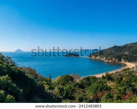 Panoramic view over the coastline with beach of Naoshima Island in the Seto Inland Sea in Japan, known for its museums of contemporary art, architecture and sculpture Royalty-Free Stock Photo #2412483801