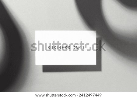 Business card on white background with shadow, top view