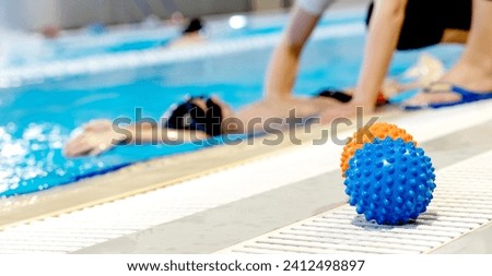 A boy with a trainer in the pool. High quality photo
