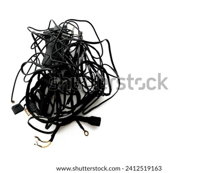 Tangled roll of black wires isolated on white background. Clip art. E-waste mess concept.