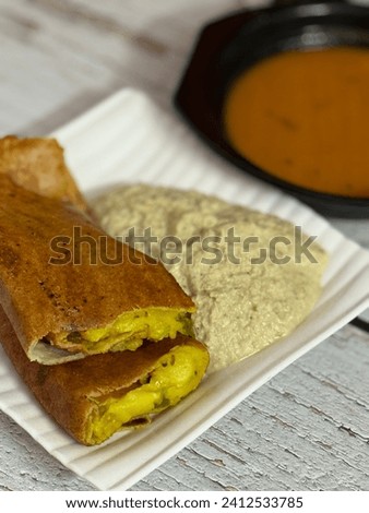 The magic of a Masala Dosa lies in its filling, known as "masala." Potatoes are seasoned with a blend of mustard seeds, cumin, curry leaves, onions, turmeric, and other spices, creating a deliciously 