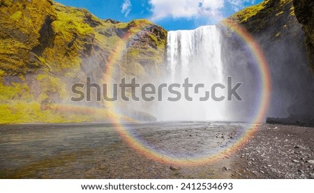 Icelandic Landscape concept - View of famous Skogafoss waterfall and amazing rounded rainbow