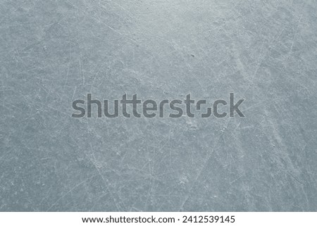Scratched ice at the ice rink as texture or background for winter composition