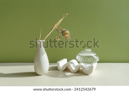 Geometric shapes with a transparent vase with beautiful light in the composition. abstract background with geometric shapes on a green background.