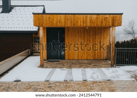 A patio outside of a home on a snowy winter day