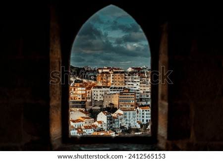 A breathtaking view of a stunning sunset from a window of a castle in Portugal, Lissabon Royalty-Free Stock Photo #2412565153