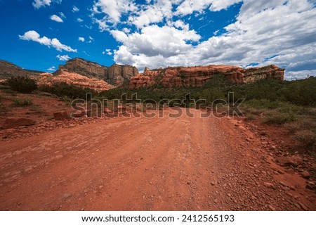 ATV riding on the Outlaw Trail in Sedona, Arizona.  The scenery has dark blue skies, rough trails, and red rocks.   Royalty-Free Stock Photo #2412565193