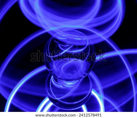 An intriguing ink blue light emanating from a light bulb in a dimly lit setting creating a mysterious aesthetic Royalty-Free Stock Photo #2412578491