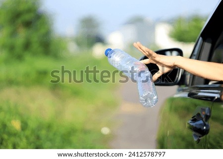 bad habits on the road, environmental pollution. unhealthy behavior by throwing plastic bottles and packaging from the car window while traveling. littering causes environmental damage. Royalty-Free Stock Photo #2412578797