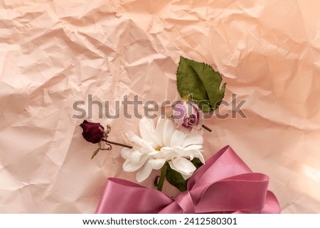 Concept shot of the background theme, wrapping paper, dried roses other flowers and other arrangements.