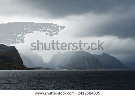 A scenic view of silhouettes of mountain range with lake foreground  during a foggy morning Royalty-Free Stock Photo #2412584035