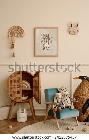 Minimalist composition of kid room interior with mock up poster frame blue armchair, plush toys, wooden blocks, rattan sideboard, beige wall with stucco, braided penguin. Home decor. Template.