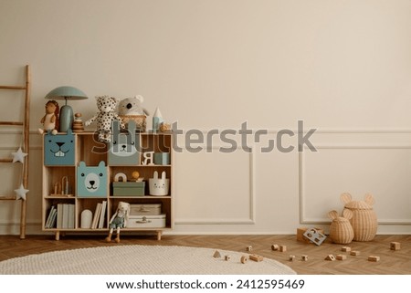 Interior design of kid room interior with copy space, wooden sideboard, round rug, beige wall with stucco, plush toys, ladder, wooden blockers and personal accessories. Home decor. Template.