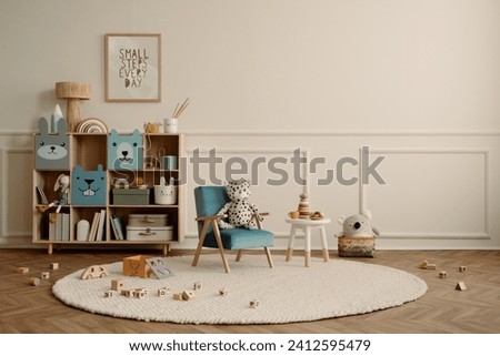 Minimalist composition of kid room interior with copy space, mock up poster frame, blue armchair, wooden sideboard, beige rug plush toys, wooden blockers and personal accessories. Home decor. Template