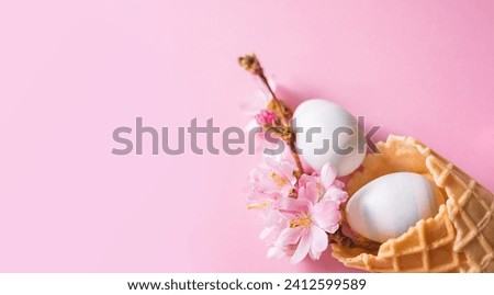 Easter banner with copy space. Easter eggs, cherry blossom flowers, waffle cone on a pink background with bokeh. Church Christian holidays, Christianity, Easter background