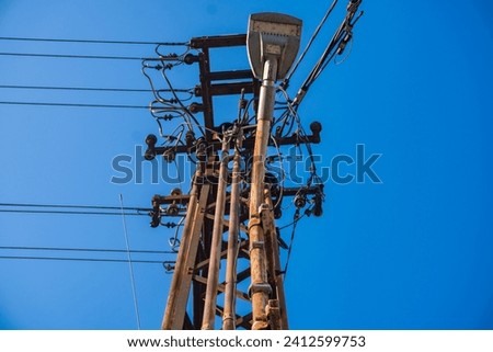 Electric poles and power lines and communication lines against the blue sky