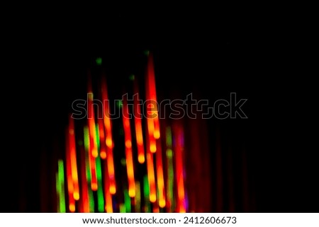 Light neon abstract lamps on black background blurry effect. Dark colorful bright neon light on black