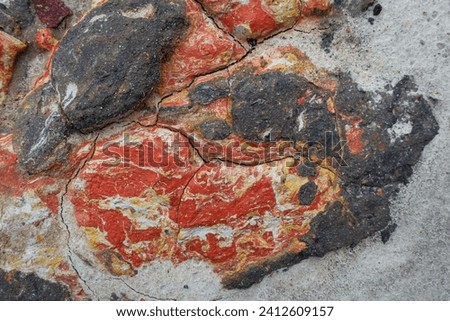 The clay surface is unique and abstract with a mixture of natural colors red, orange and gray