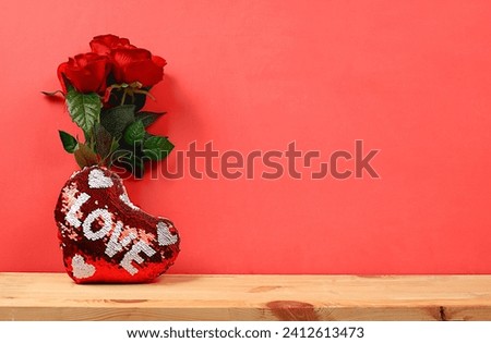 Concept for Valentine's Day or Women's Day, Mother's Day, banner. Greeting card, roses, hearts and gift boxes on a red background, happy holiday, birthday greetings, selective focus