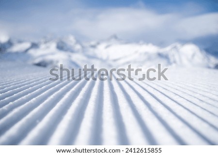 Snow slope for skiing and snowboarding. Velvet. Winter sports. Slope and mountains. Composition in winter time. Wallpaper and background.