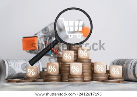 Inflation concept Inflation soars with recessions and crises. Graph of rising inflation, taxes, food and drinks. Cart icon on magnifying glass with percentage icon on wooden block white background