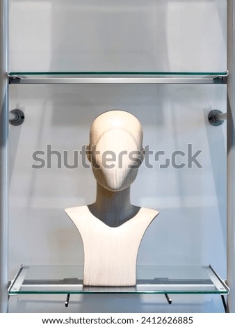 A head and shoulders mannequin used to elegantly display the latest fashion trends in-store, showcasing clothing with poise and style. 