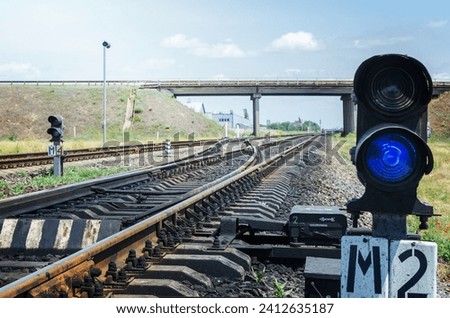 blue semaphore and railroad crossing